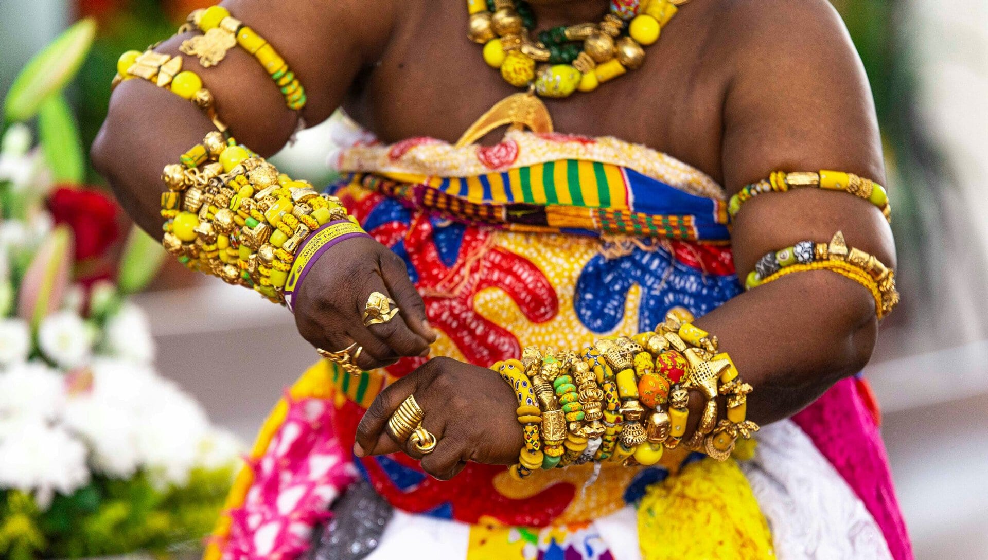 Colorful traditional attire and jewelry at World Methodist Evangelism event.