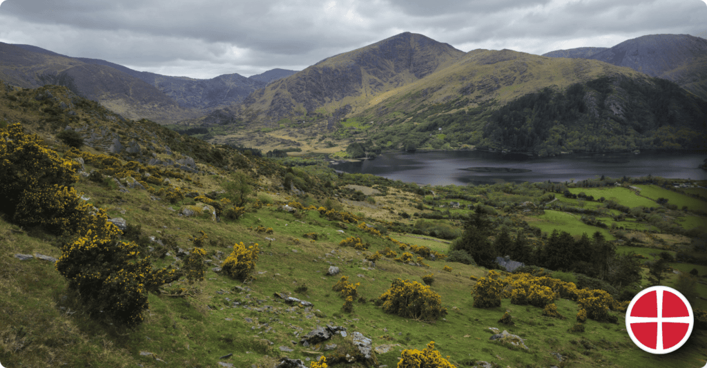 Beautiful mountain landscape with lake and green valleys in the distance.