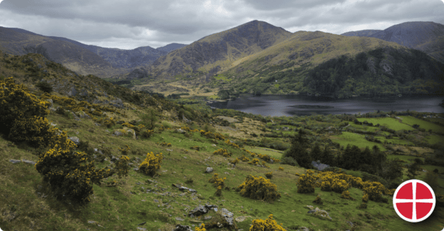 Beautiful mountain landscape with lake and green valleys in the distance.