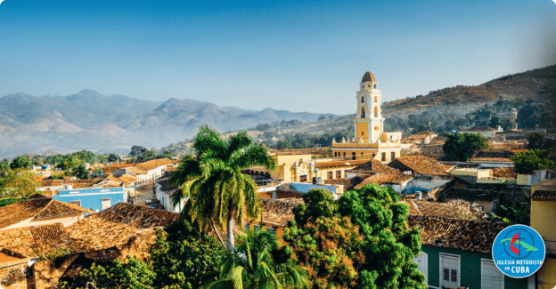 Scenic view of a Cuban town with church and mountains in the background.