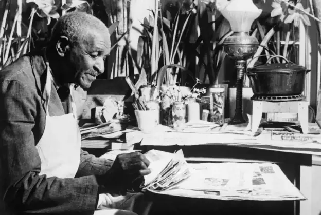 Elderly man reading a newspaper at a desk with plants and books, promoting Methodist evangelism.