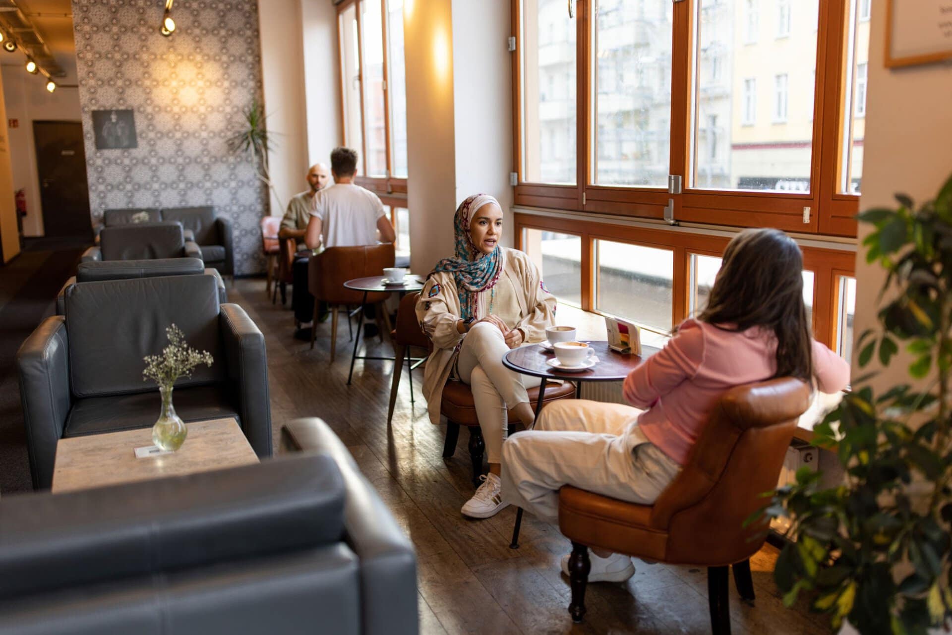 People engaging in conversation at a coffee shop for World Methodist Evangelism.