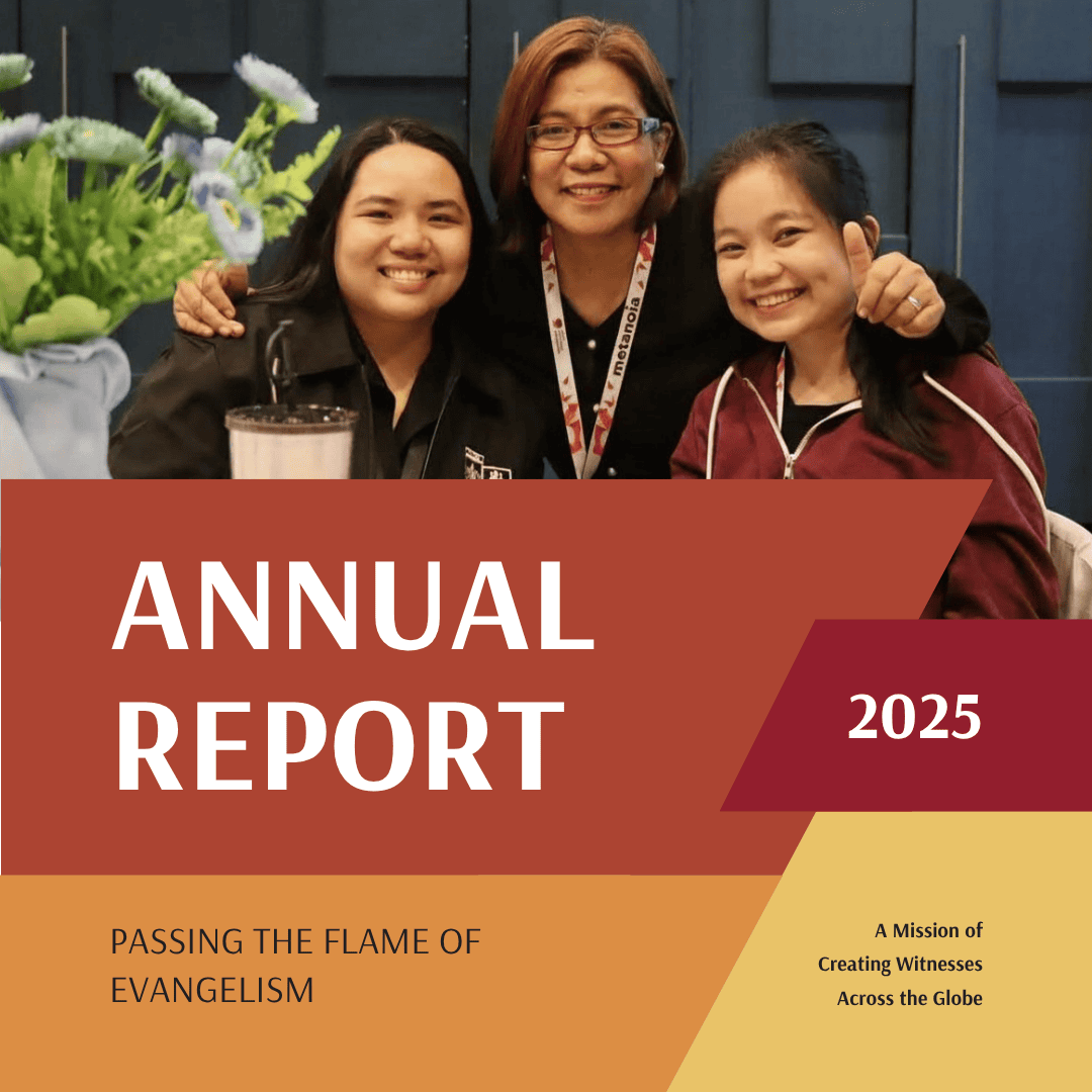 Group of people at World Methodist Evangelism event with annual report display.