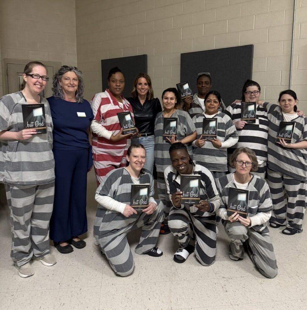Women in prison holding Bibles during a World Methodist Evangelism event.