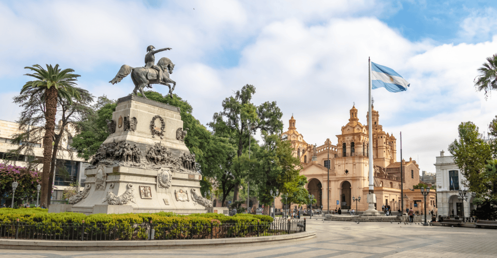 Statue and historic church in a city square, Argentina, for World Methodist Evangelism.